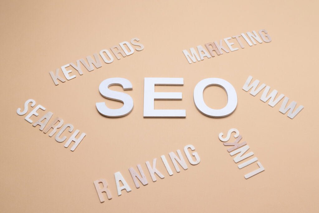 Local SEO Essentials: 3 Key Elements Explained 4 SEO The word SEO spelled out on a beige background, highlighting local SEO.