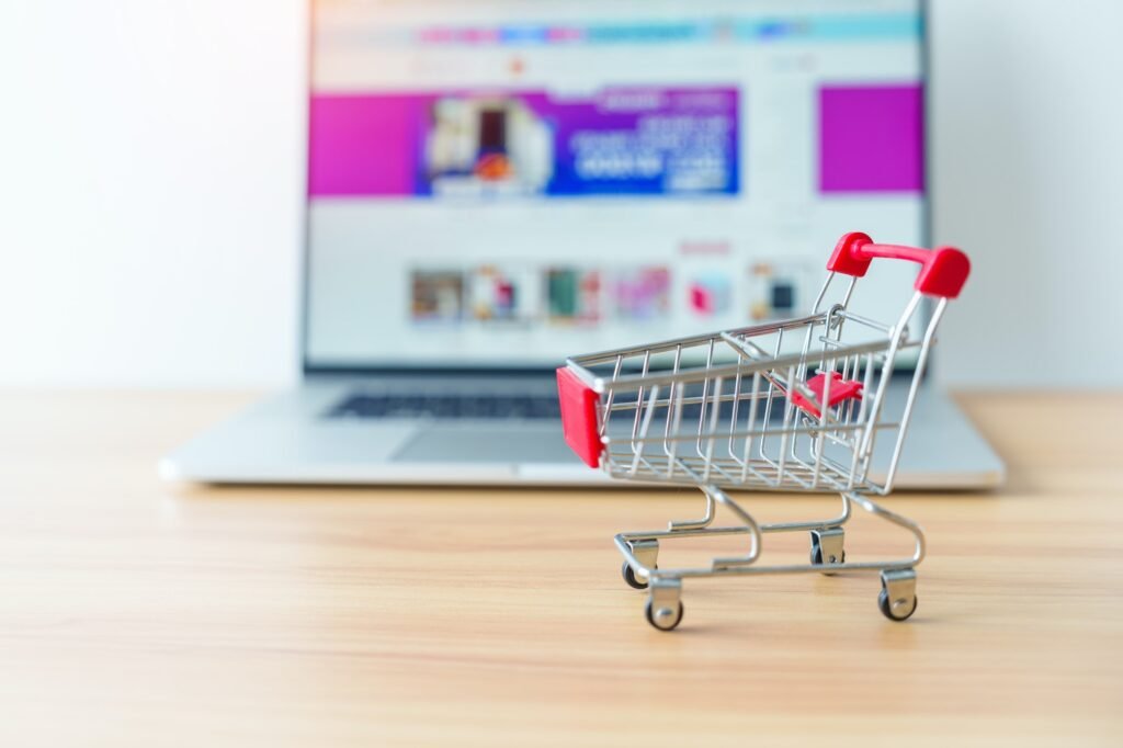 E-commerce SEO Services: Boost Your Online Store's Ranking 3 Shopping cart and laptop computer with marketplace website.