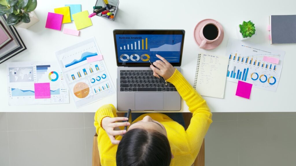 SEO Company: Are Their Services Worth the Investment? 2 Above top desk of SME owner people home office call talk in SEO chart sale report