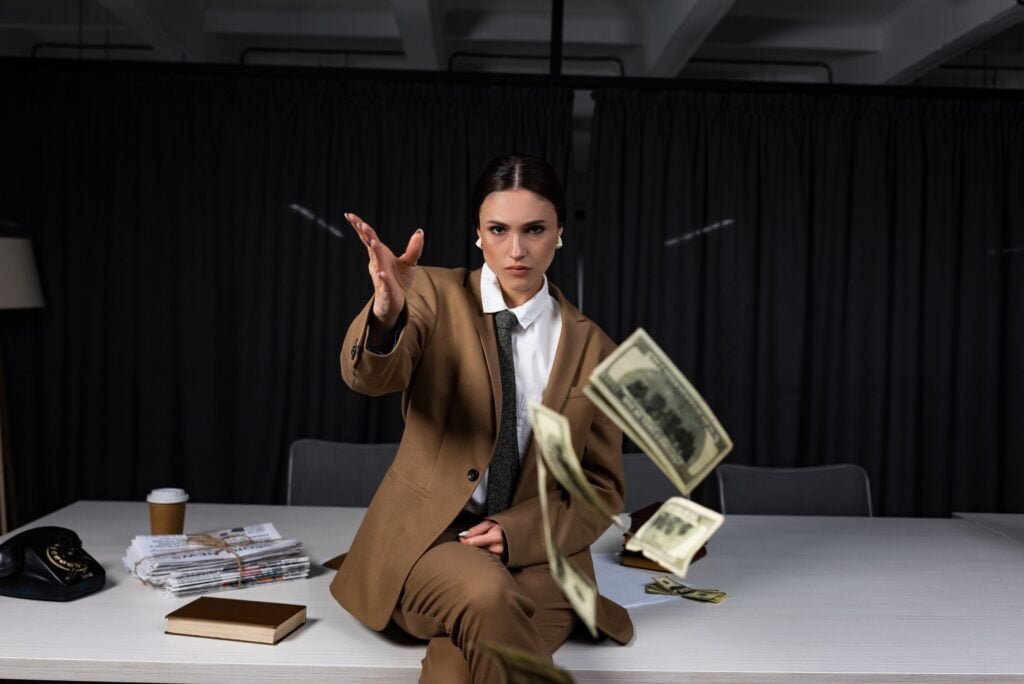 Do you have to pay for SEO? Exploring the Cost Factors and Benefits 3 businesswoman sitting on table, throwing money and looking at camera